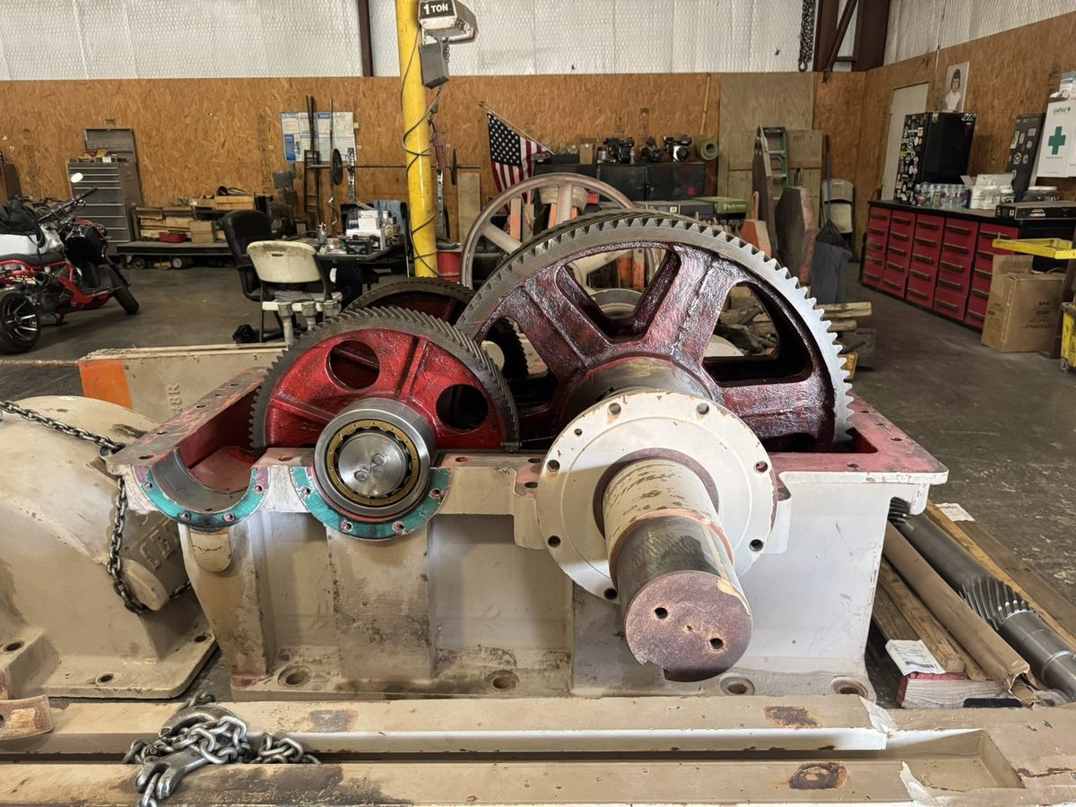 Open pumping unit gearbox with its gears and bearings in Snelson's shop