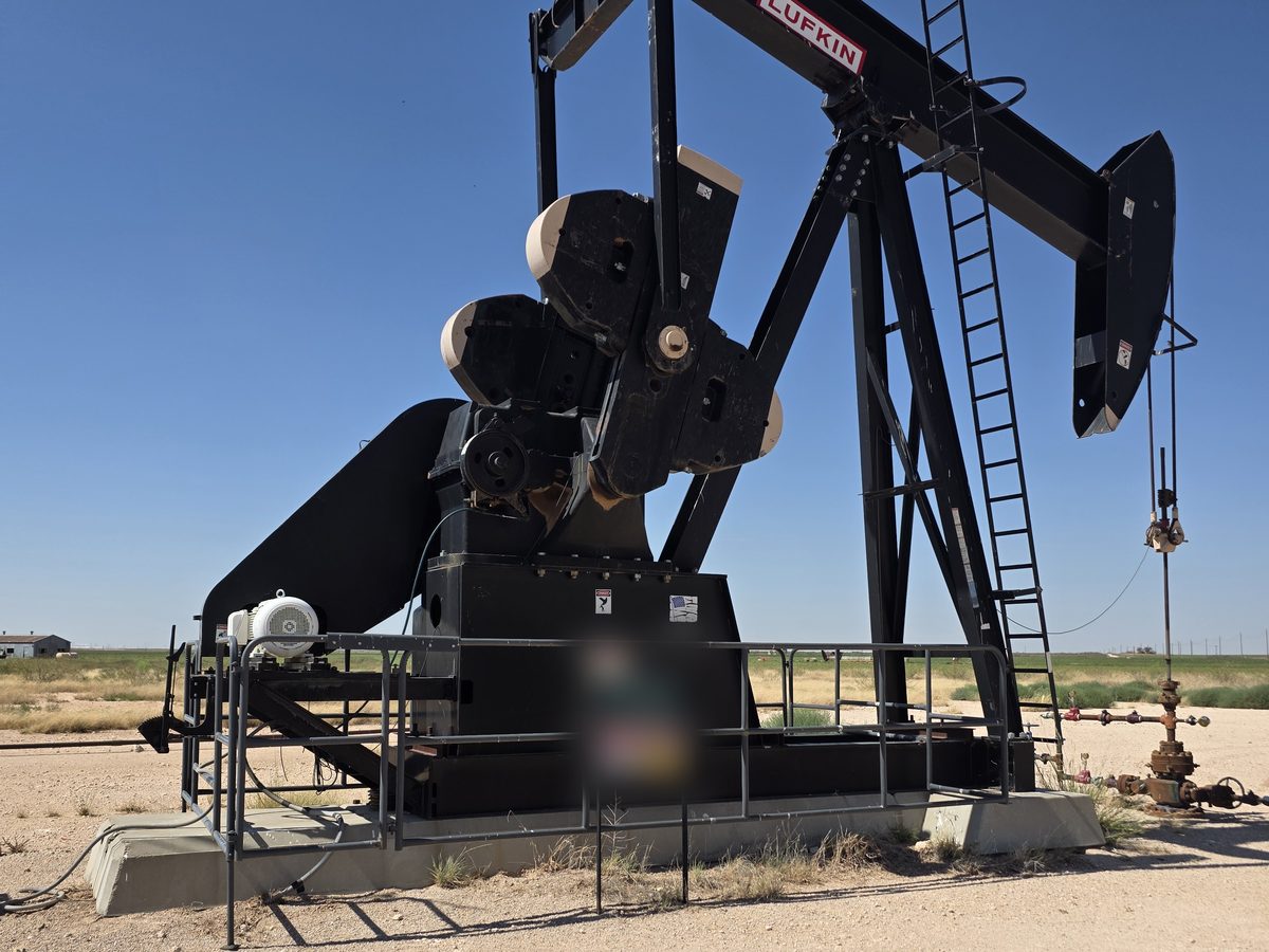 Black Lufkin pumping unit with the Lufkin nameplate on the walking beam