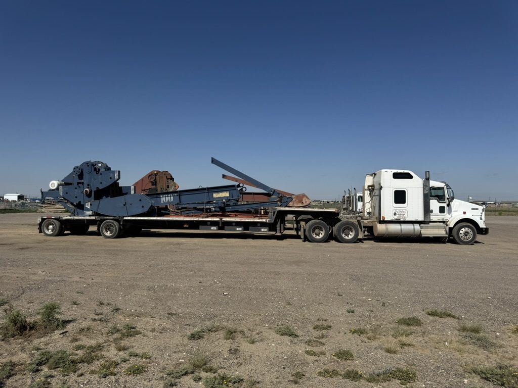 Snelson's truck hauling a pumping unit on a lowboy trailer